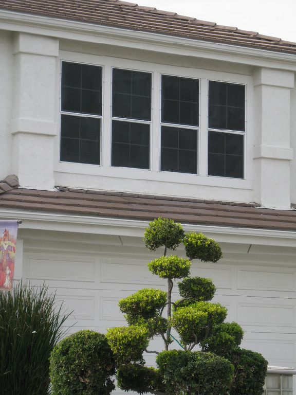 Residential exterior with durable window screens