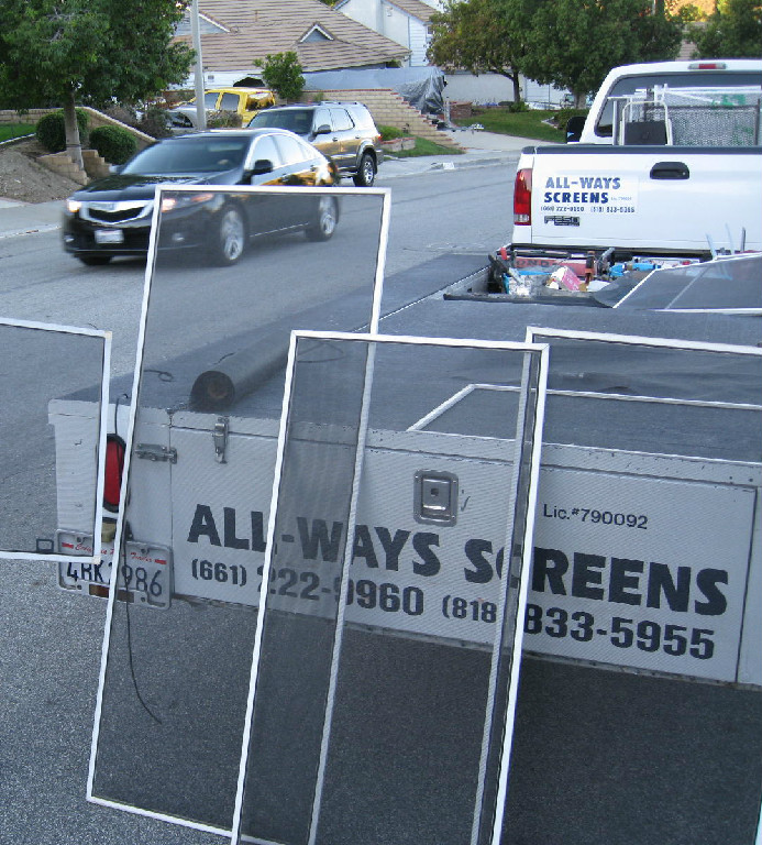 Window screen panels and ALL-WAYS SCREENS equipment at a job site